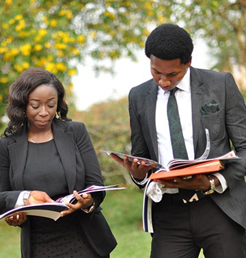 BIU-graduates-reading-in-field